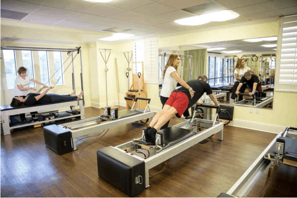 Man in his 50s at MatWorkz Pilates being instructed in Pilates