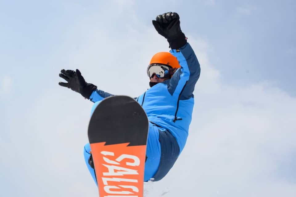 Man snowboarding without injury because of Pilates at MatWorkz Pilates