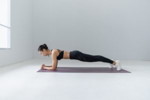 A practitioner of Pilates using a Pilates mat during practice