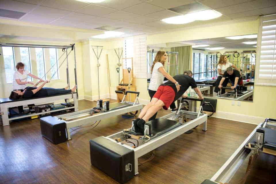 MatWorkz Pilates instructor working with a student on proper Pilates technique