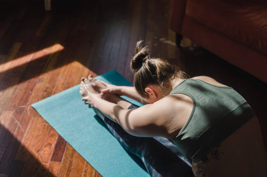 A student does a Pilates Roll-up exercise at MatWorkz Pilates