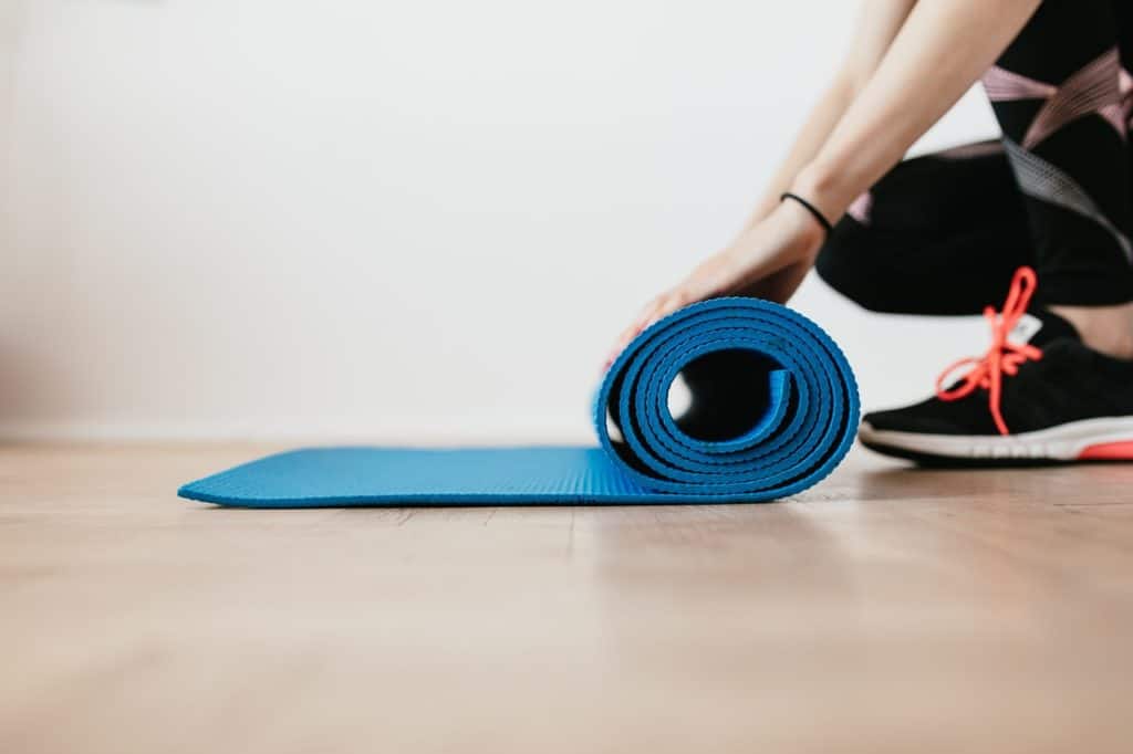 A Pilates student rolling up their mat after practice at MatWorkz Pilates Orlando