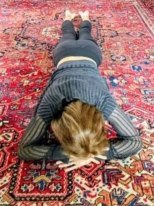 Woman lying prone in belly time position on the floor